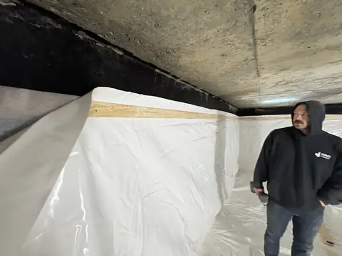 Cistern liner fastened along the top of the wall to wood strapping
