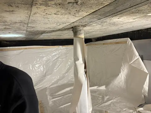 Centre support post in a cistern being wrapped with liner material
