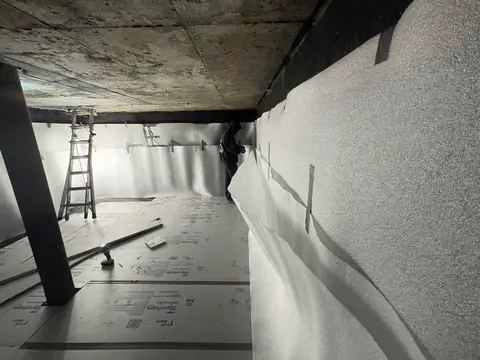 Foam padding on the cistern walls and rigid foam board on the floor before the liner goes in