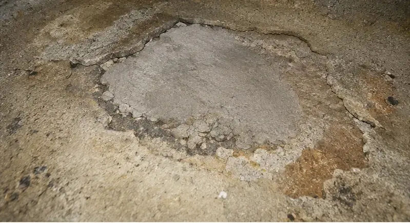 Failed repair and deteriorating surface inside a cistern