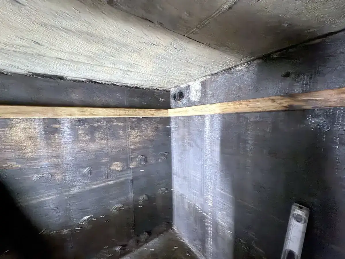 Cistern liner installation: Strapping runs level and continuous, butted tight at the corner.