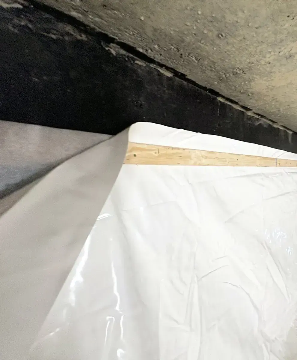 Cistern liner installation: Liner brought up to the perimeter strapping.
